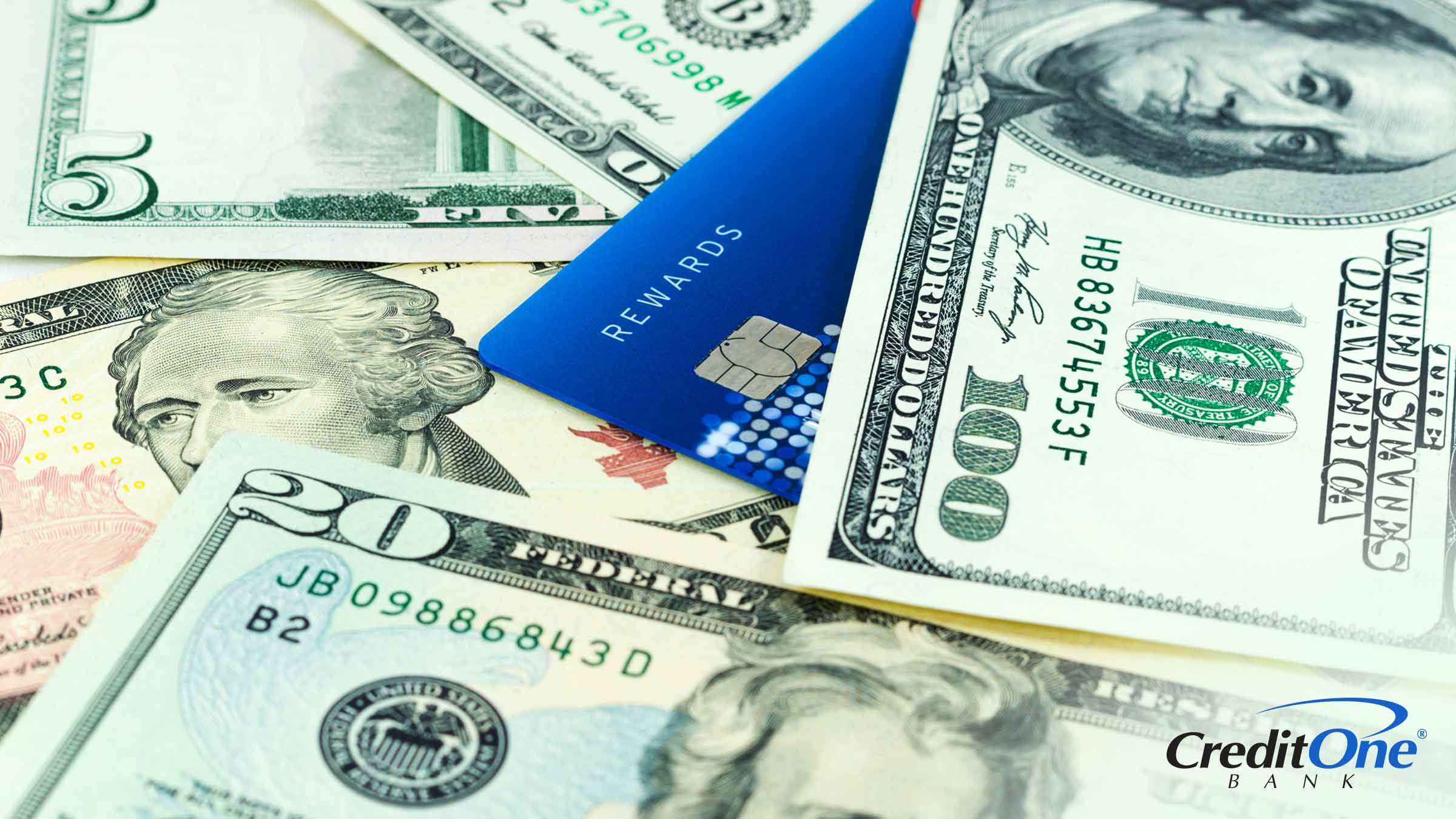 A credit card marked “rewards” sits in a pile of USD bills, representing how you can maximize your credit card rewards.